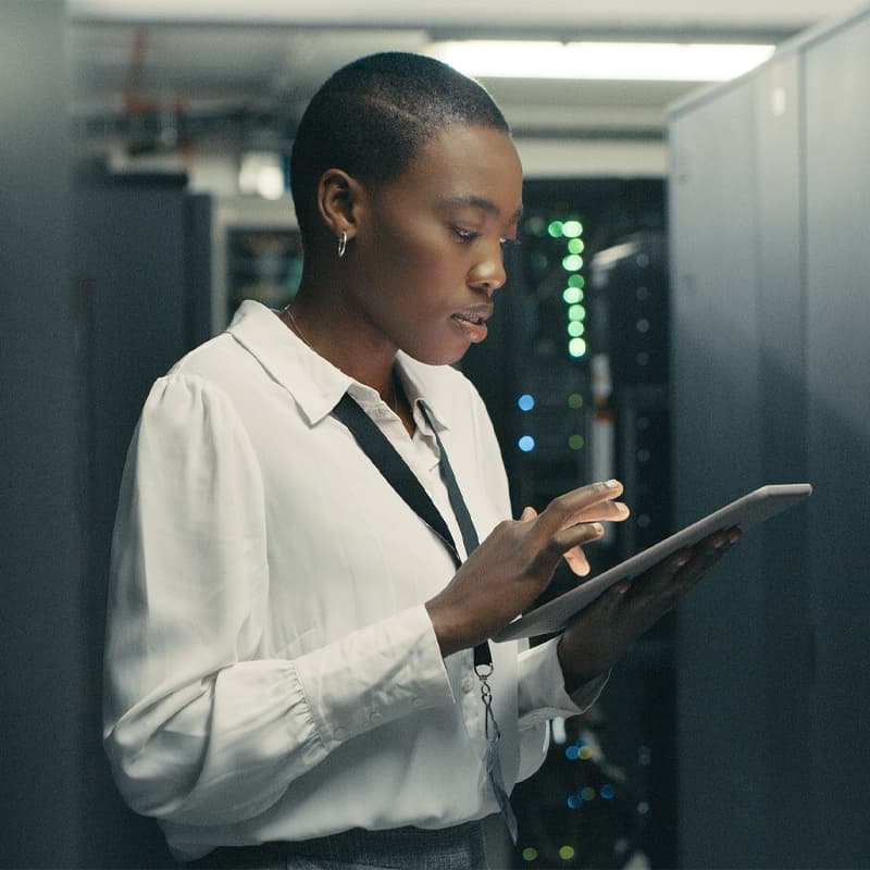 Shot of a young woman using a digital tablet while working in a data centre.
