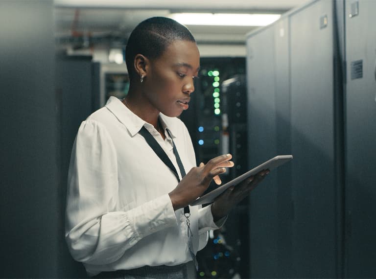 Shot of a young woman using a digital tablet while working in a data centre.
