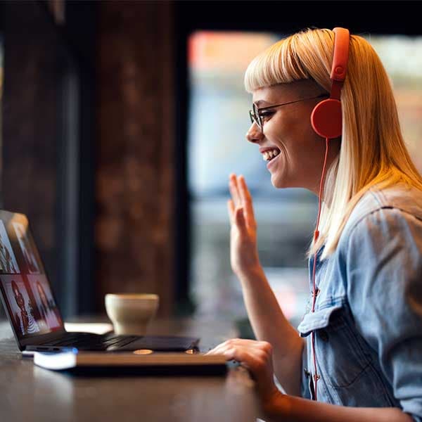 Permalancer waving at their team members working remotely