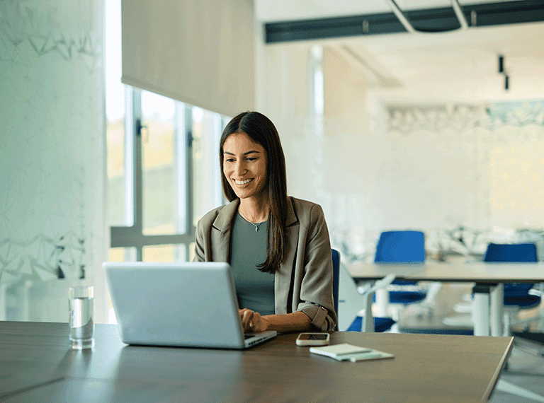 Employee on laptop smiling