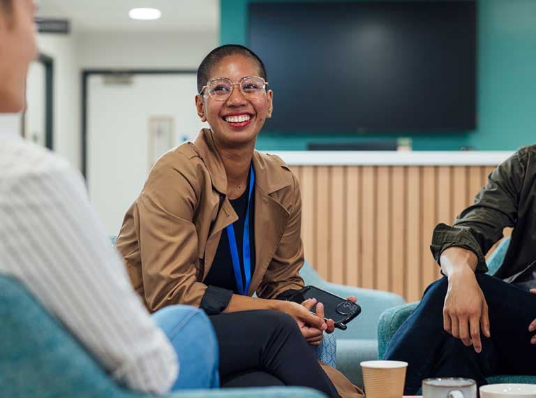 Employee talking to colleagues smiling