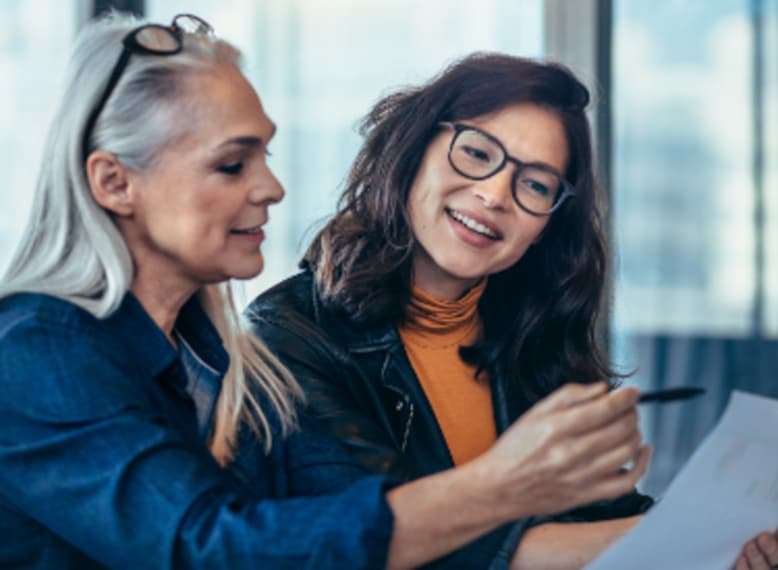 Two people looking at a page